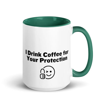 White ceramic mug that is green inside and on the handle with the words, "I drink coffee for your protection"