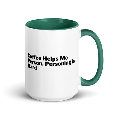 White ceramic mug with green inside and on the handle with the words, "Coffee helps me person, personing is hard"