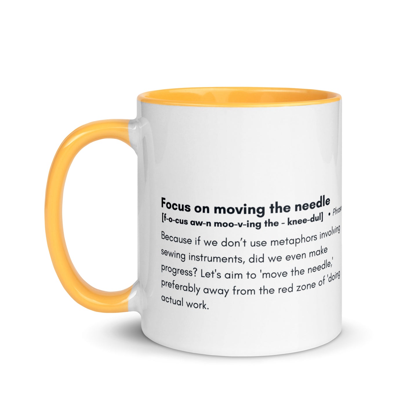 Ceramic white cup with golden yellow inside and handle with the words, "focus on moving the needle" followed by a humorous definition 