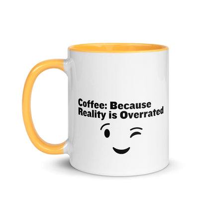 White ceramic mug with golden yellow on the inside and on the handle with the words, "Coffee: Because reality is overrated"