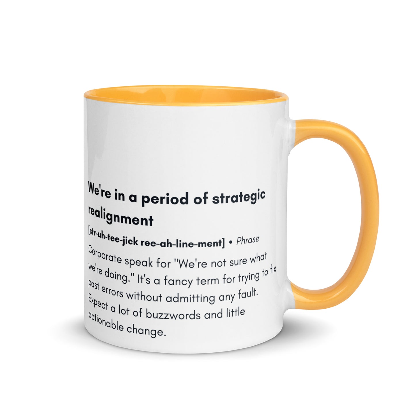 ceramic white mug with dark yellow inside and handle with the words "we're in a period of strategic realignment" with a humorous definition. 