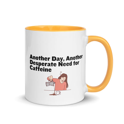 White ceramic coffee mug with yellow and handle with the words, "Anotehr day, another desperate need for caffeine" 