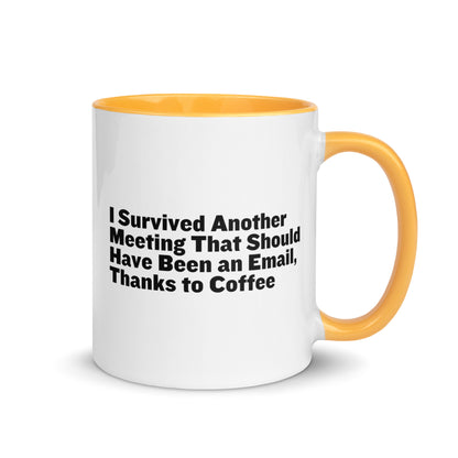 White ceramic mug with golden yellow inside and on the handle with words that say, "I survived another meeting that should have been an email, thanks to coffee"