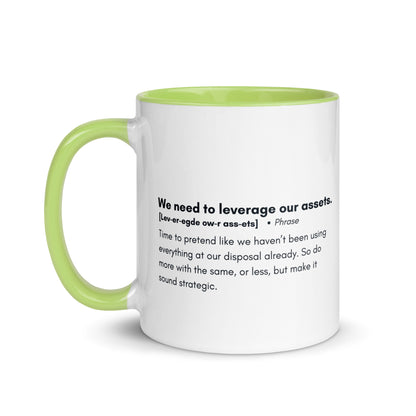 White ceramic mug with lime green inside and handle with the words, "We need to leverage our assets" followed by a humorous definition.