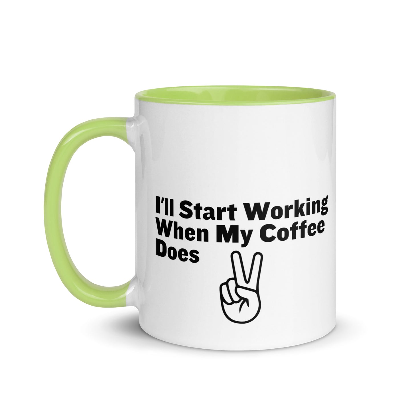 White ceramic mug with a lime green inside and handle with the words, "I'll start working when my coffee does"