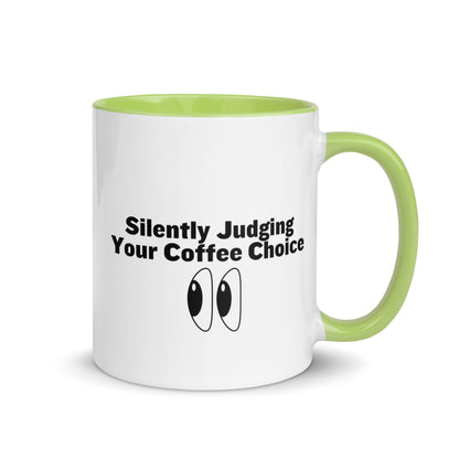 White ceramic mug with lime green inside and handle with the words, "Silently judging your coffee choice"