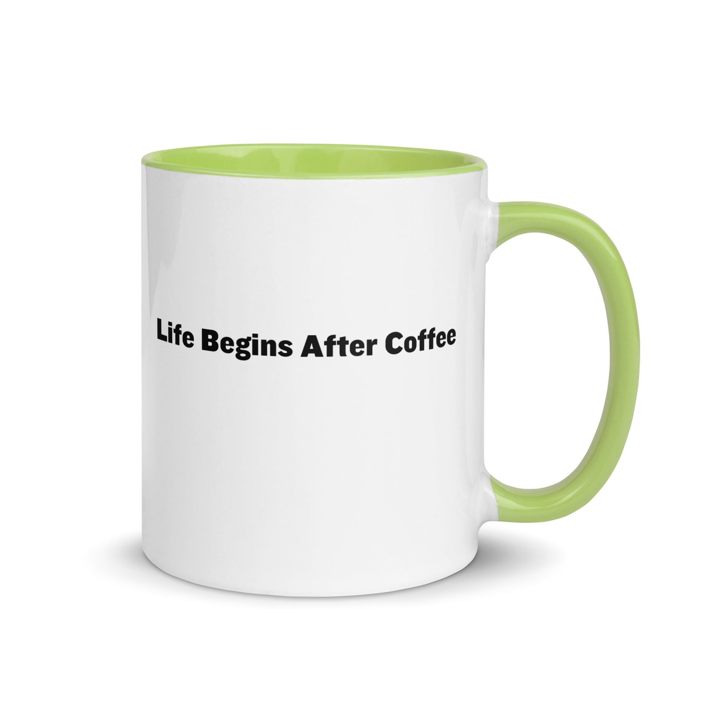 White ceramic mugs with lime green inside and handle with the words, "Life begins after coffee"