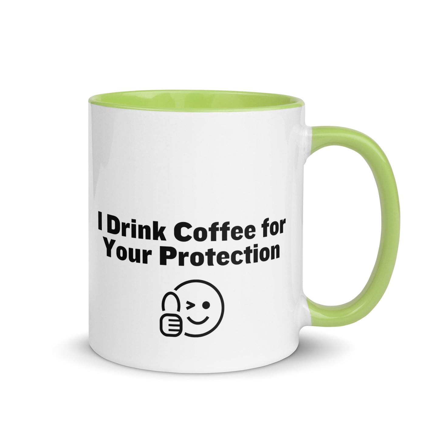 White ceramic mug that is lime green inside and on the handle with the words, "I drink coffee for your protection"