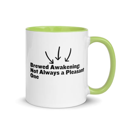 White ceramic mug with lime green on the inside and on the handle with the words, "Brewed awakening: Not always a pleasant one