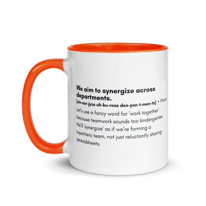 White ceramic mug with orange inside and handle with word,"We aim to synergize across departments" followed by a humorous definition.