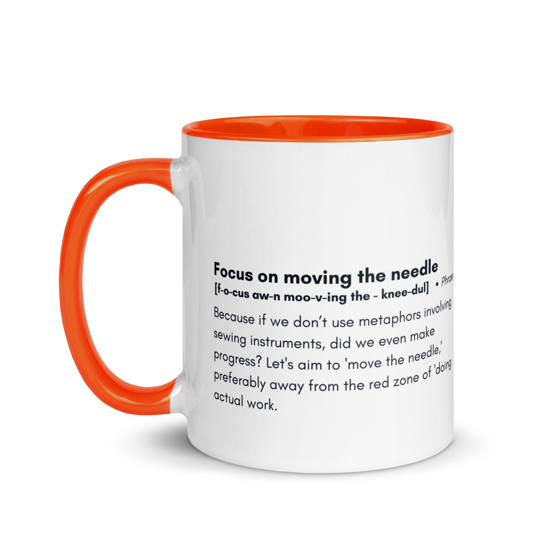 Ceramic white cup with orange inside and handle with the words, "focus on moving the needle" followed by a humorous definition 