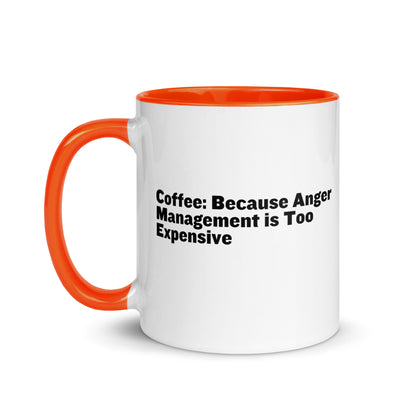 White ceramic mug with orange inside and on the handle with the words, "Coffee: Because Anger management is too expensive"