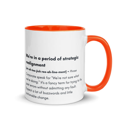 ceramic white mug with orange inside and handle with the words "we're in a period of strategic realignment" with a humorous definition. 