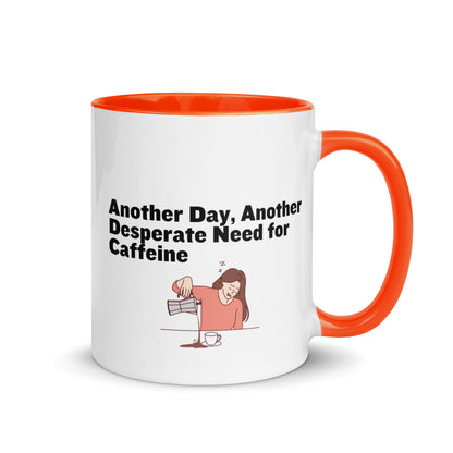 White ceramic coffee mug with orange inside and handle with the words, "Anotehr day, another desperate need for caffeine" 