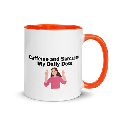 White ceramic mug with orange on the inside and on the handle with words that say, "Caffeine and Sarcasm: My daily dose"