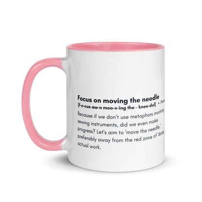 Ceramic white cup with light pink inside and handle with the words, "focus on moving the needle" followed by a humorous definition 