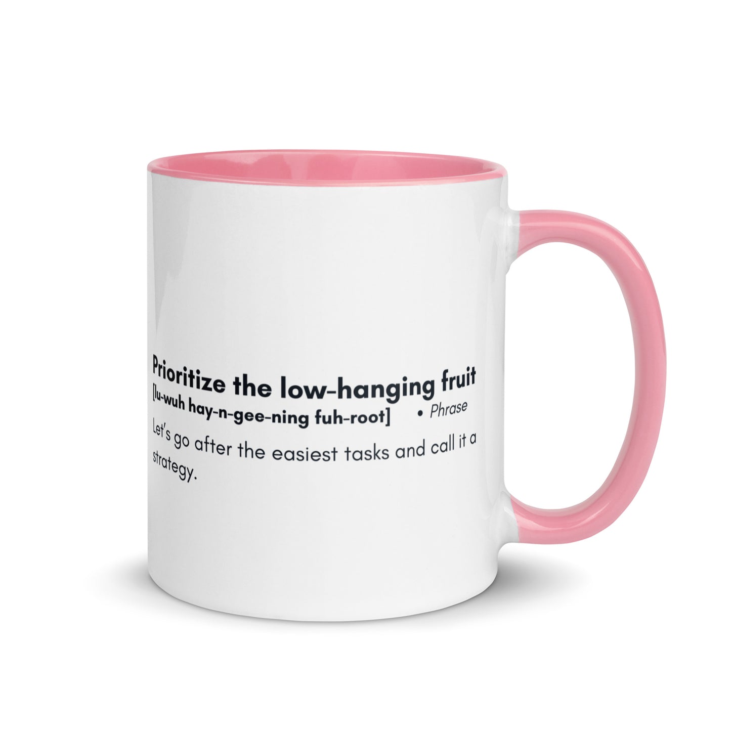 White ceramic mug with pink inside and handle with words "Prioritize the low hanging fruit" followed by a humorous definition. 