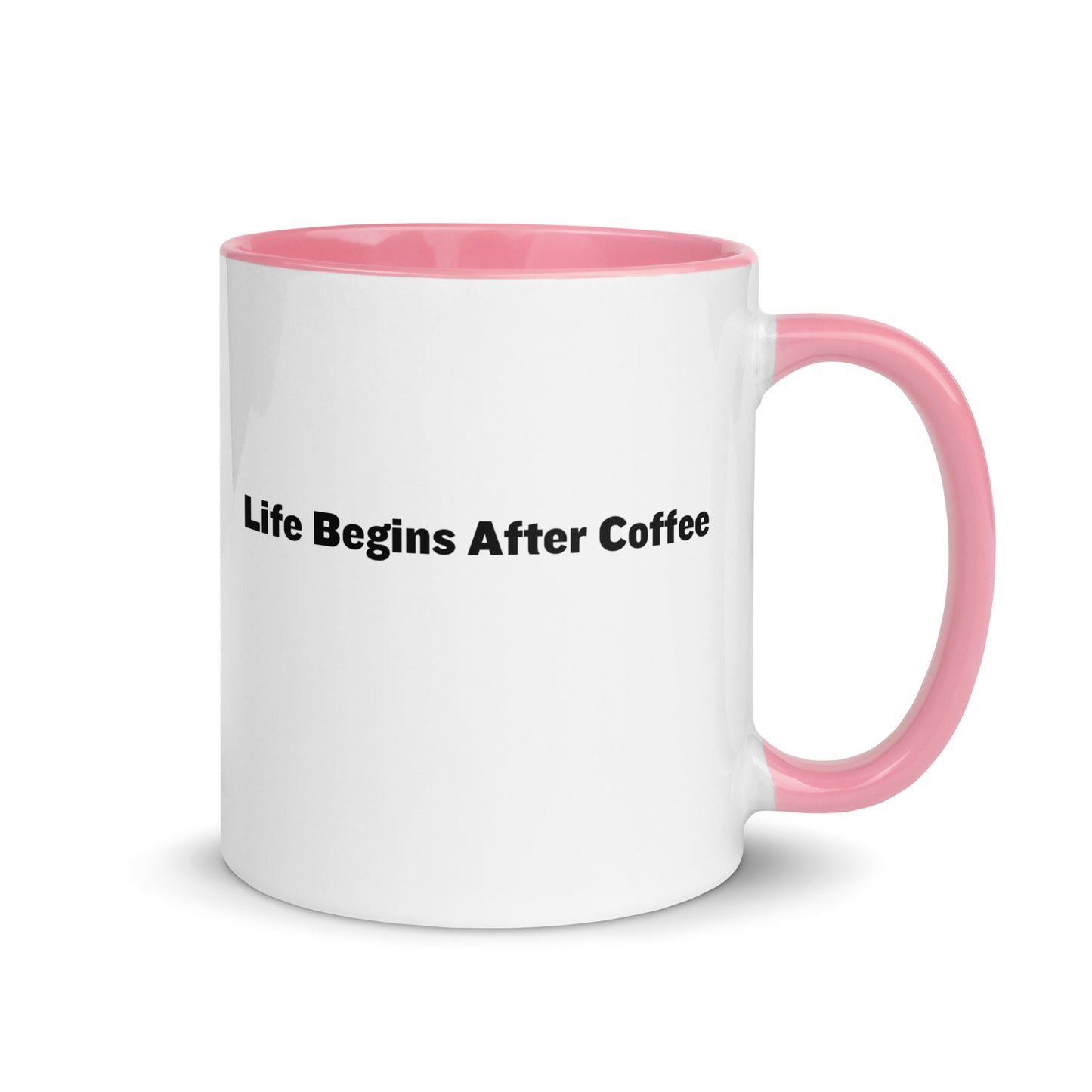 White ceramic mugs with pink inside and handle with the words, "Life begins after coffee"