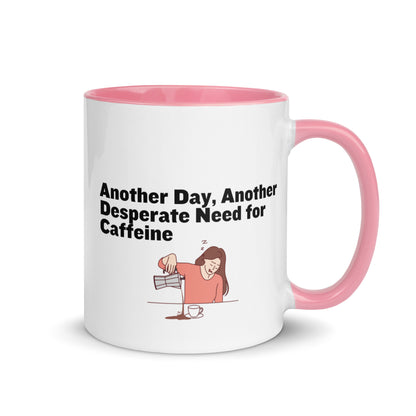 White ceramic coffee mug with pink inside and handle with the words, "Anotehr day, another desperate need for caffeine" 