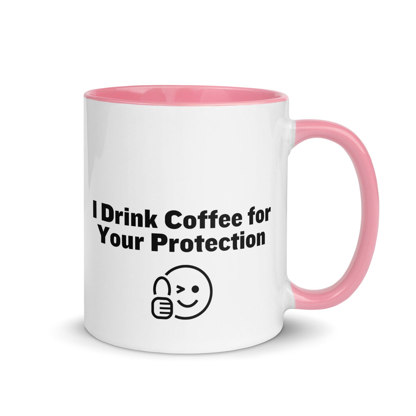 White ceramic mug that is pink inside and on the handle with the words, "I drink coffee for your protection"