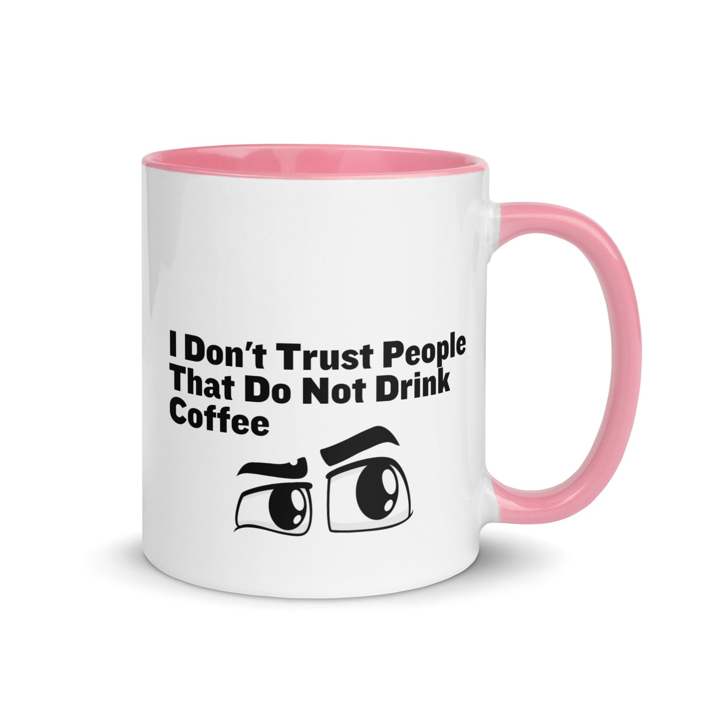 White ceramic mud with pink on the inside and on the handle with the words, "I don't trust people that do not drink coffee"