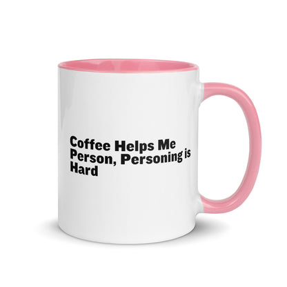 White ceramic mug with pink inside and on the handle with the words, "Coffee helps me person, personing is hard"