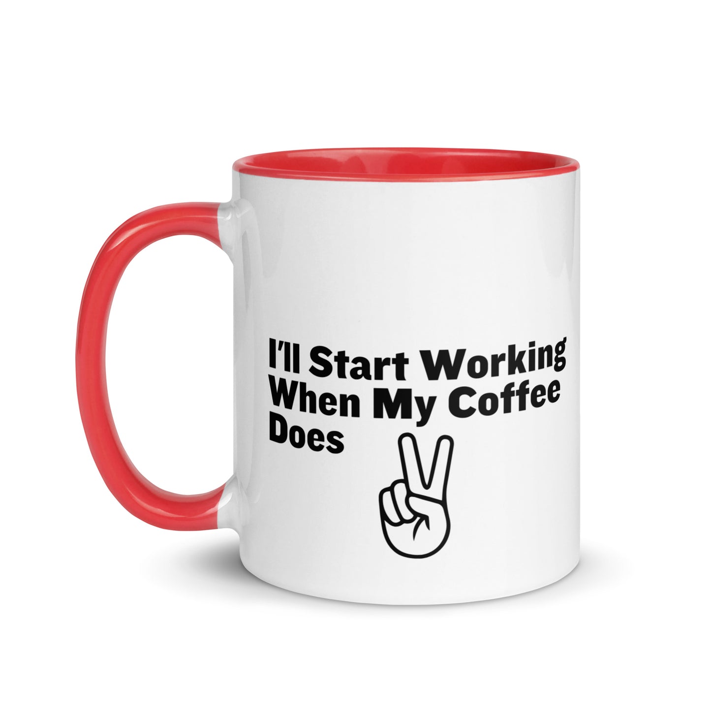 White ceramic mug with a red inside and handle with the words, "I'll start working when my coffee does"