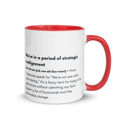 ceramic white mug with red inside and handle with the words "we're in a period of strategic realignment" with a humorous definition. 