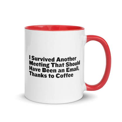 White ceramic mug with red inside and on the handle with words that say, "I survived another meeting that should have been an email, thanks to coffee"