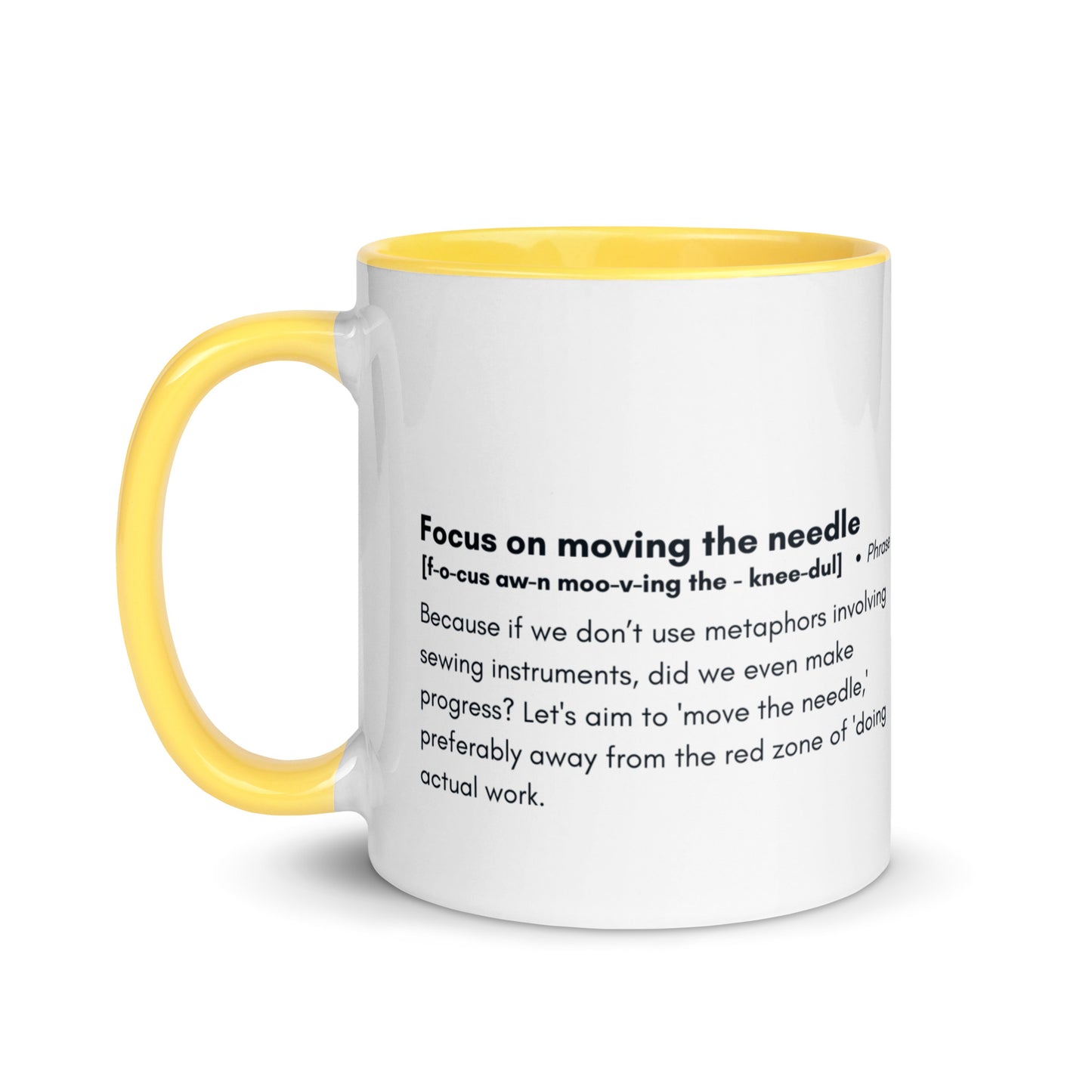 Ceramic white cup with yellow inside and handle with the words, "focus on moving the needle" followed by a humorous definition 