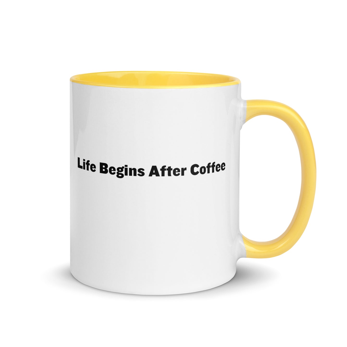 White ceramic mugs with yellow inside and handle with the words, "Life begins after coffee"