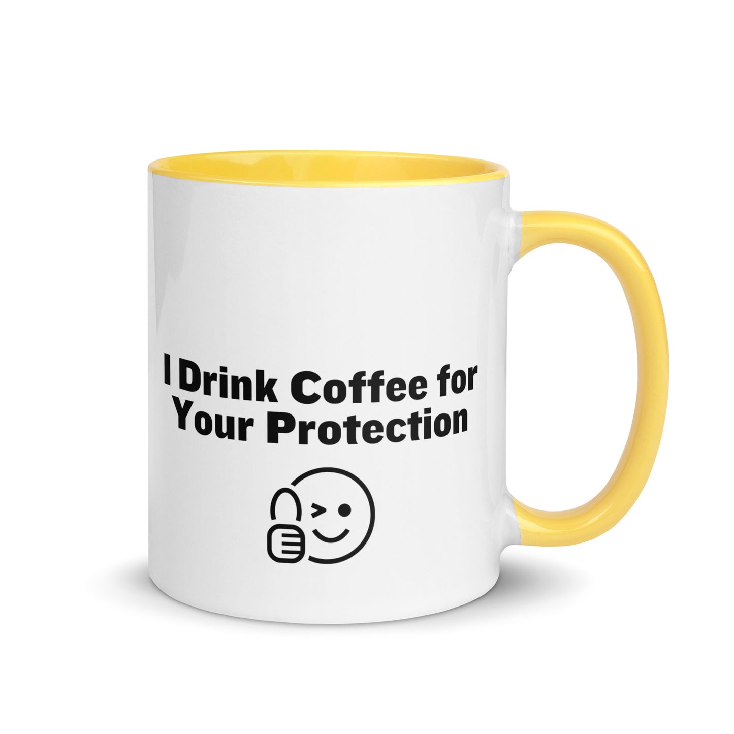 White ceramic mug that is yellow inside and on the handle with the words, "I drink coffee for your protection"