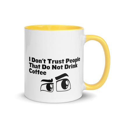 White ceramic mud with yellow on the inside and on the handle with the words, "I don't trust people that do not drink coffee"