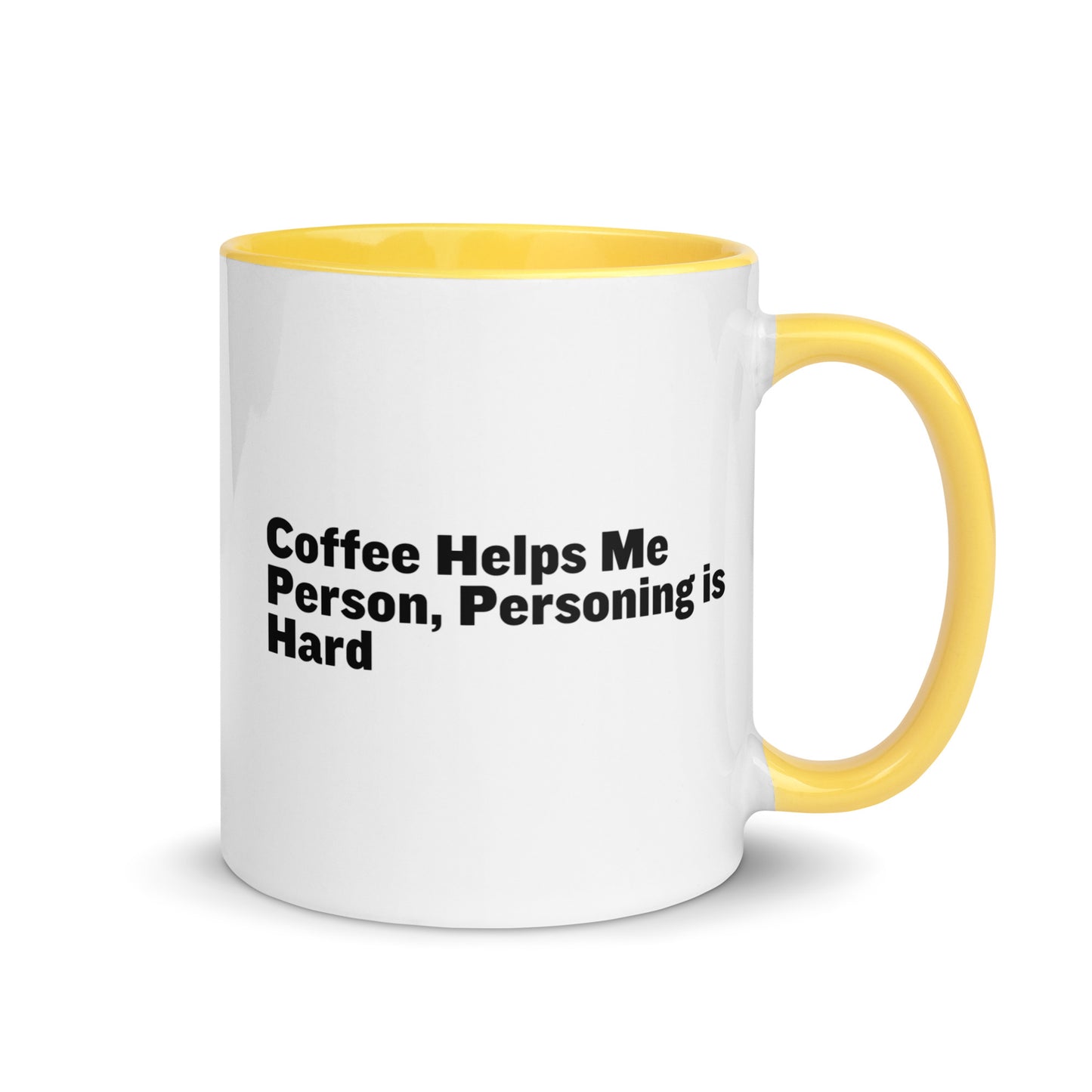 White ceramic mug with yellow inside and on the handle with the words, "Coffee helps me person, personing is hard"