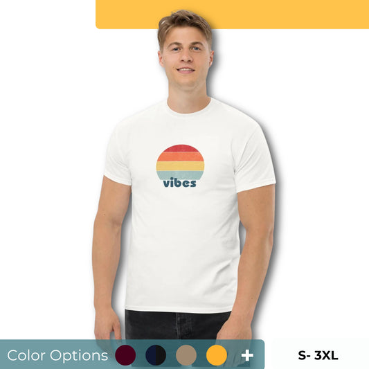 Confident man sporting a white classic tee with a colorful retro sunset design and 'vibes' text, evoking a relaxed and inspiring mood. Also showing the color and size options