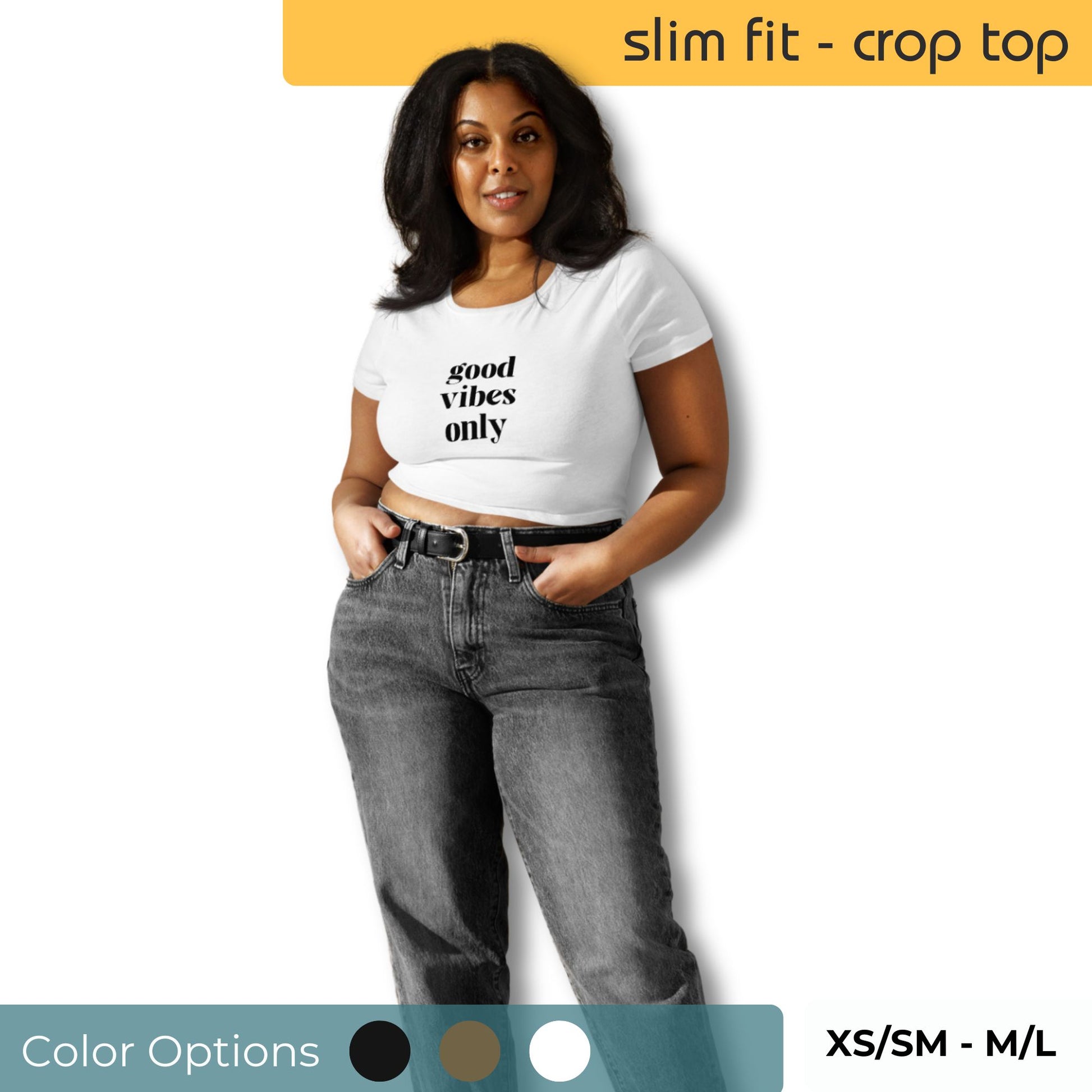 Woman modeling a white slim-fit crop top with 'good vibes only' slogan, paired with high-waisted grey jeans, available in various sizes and color options indicated by swatches.