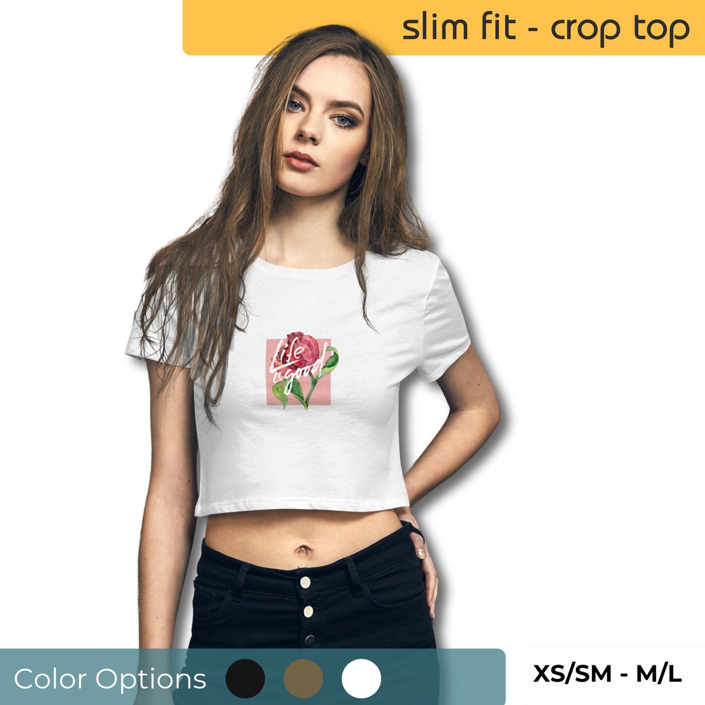 Woman wearing a white slim-fit crop top with a 'Life is Good' rose design, paired with black high-waisted jeans, available in XS/SM to M/L sizes.