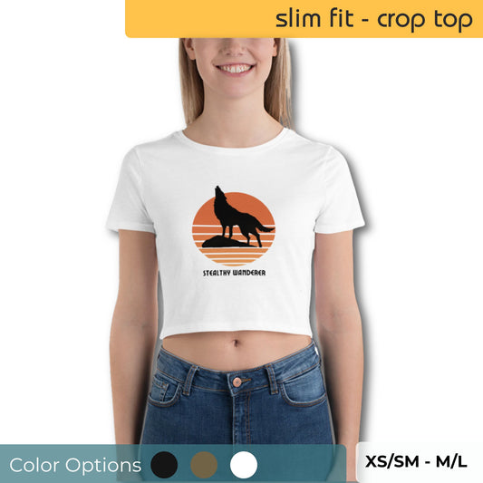 Happy young woman wearing a white crop top with a silhouette of a wolf against an orange backdrop and the phrase "STEALTHY WANDERER" below.