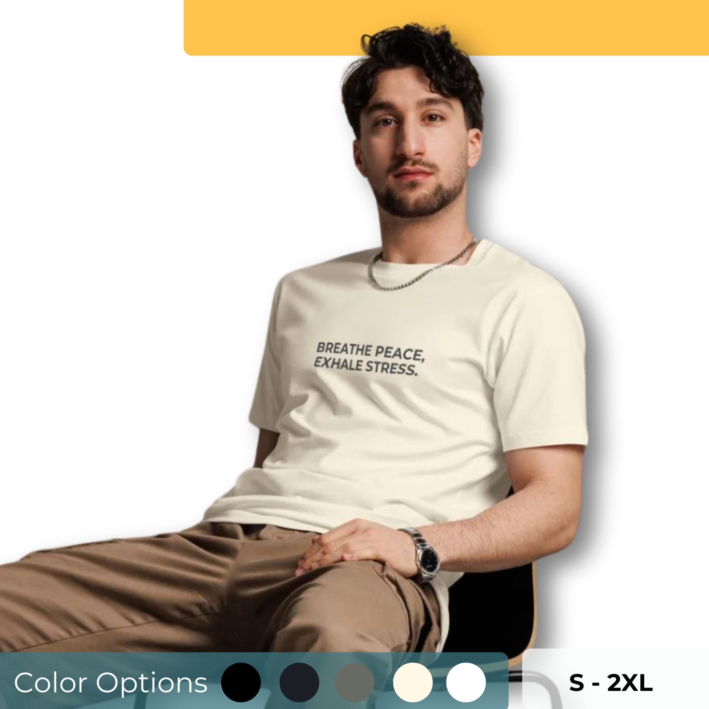 Man sitting wearing a beige premium tee with the text "Breathe Peace, Exhale Stress".