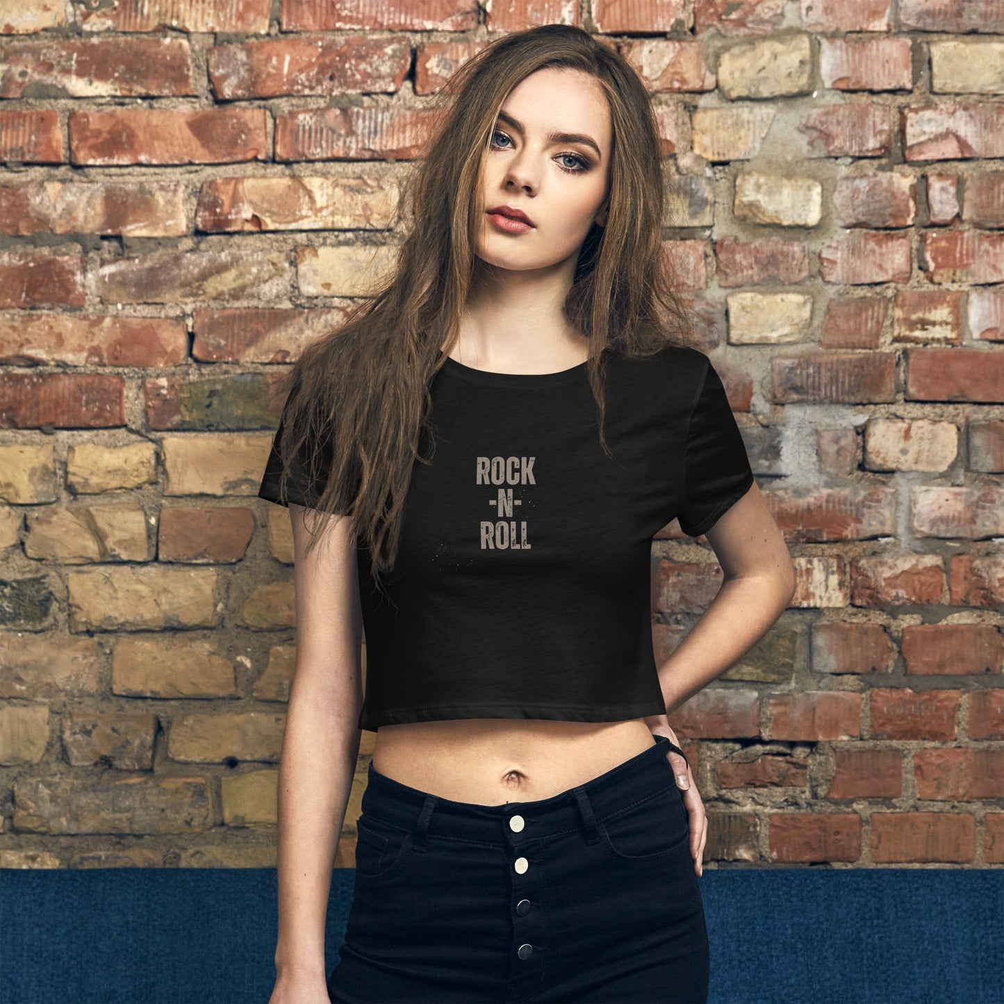 Stylish woman wearing a black 'ROCK -N- ROLL' slogan crop top, combining classic rock edge with modern street style.