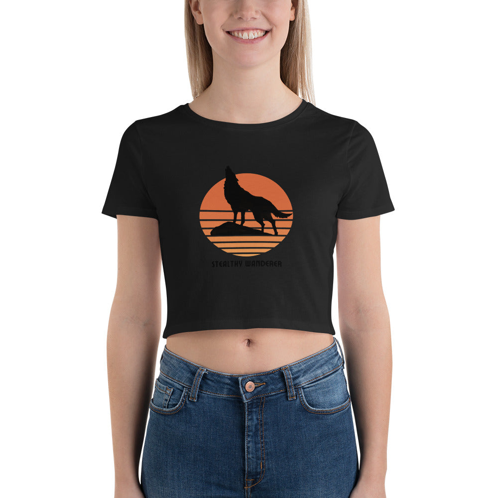 Smiling woman in a black bravery-themed wolf graphic crop top, embodying a spirit of adventure and individuality.