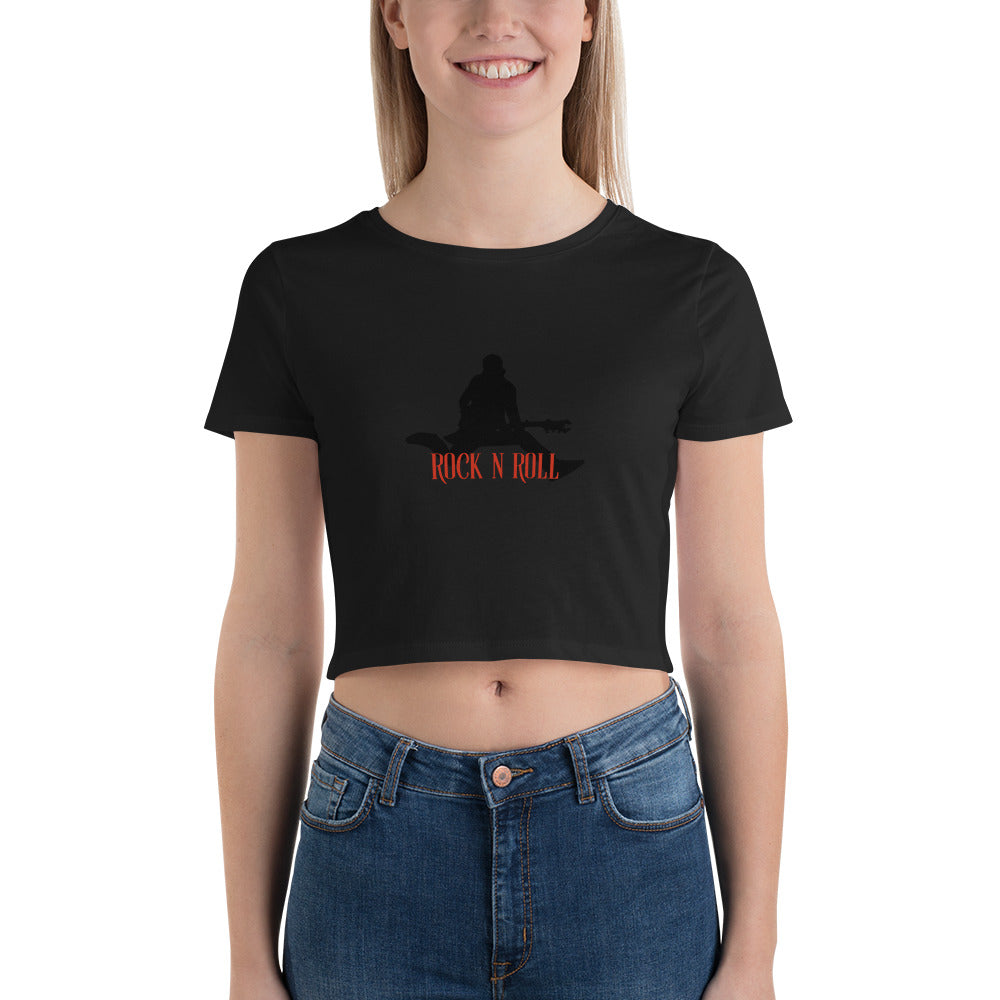 Smiling woman sporting an black crop top featuring a bold "Rock N Roll" slogan and guitarist silhouette.