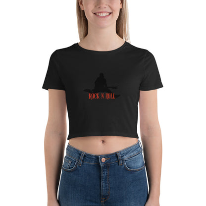 Smiling woman sporting an black crop top featuring a bold "Rock N Roll" slogan and guitarist silhouette.