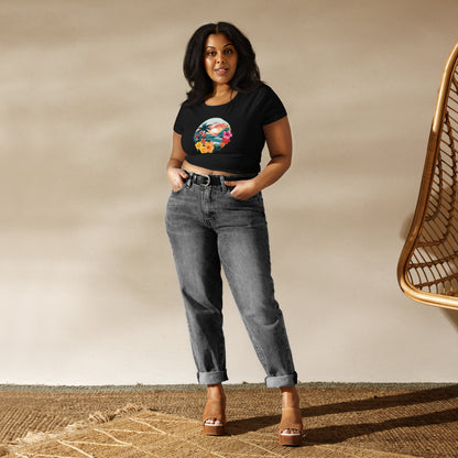 Confident woman wearing a black crop top with a colorful tropical print design, radiating inspiration and summer vibes.