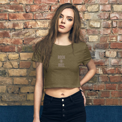 tylish woman wearing a heathered olive 'ROCK -N- ROLL' slogan crop top, combining classic rock edge with modern street style.