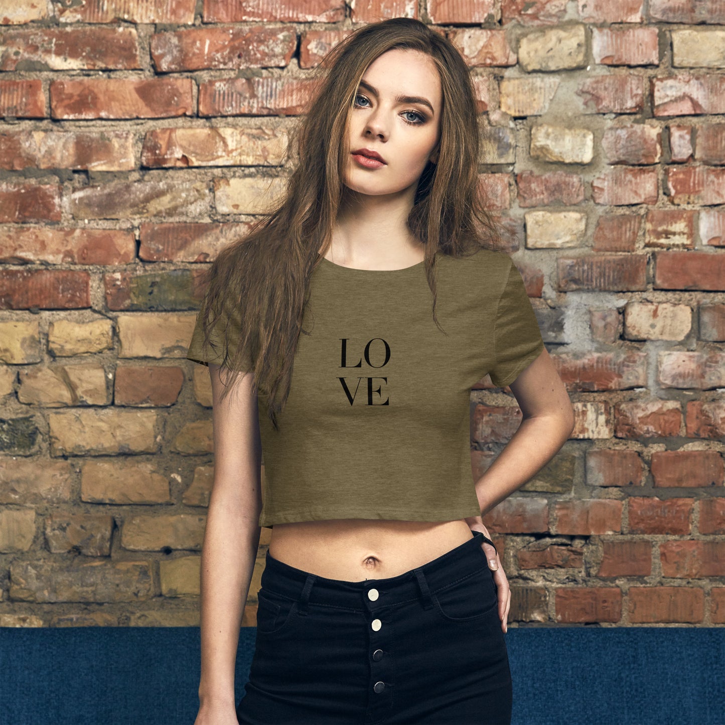 Stylish woman in a heathered green crop top with a simple 'LOVE' print, combining modern fashion with a timeless message.