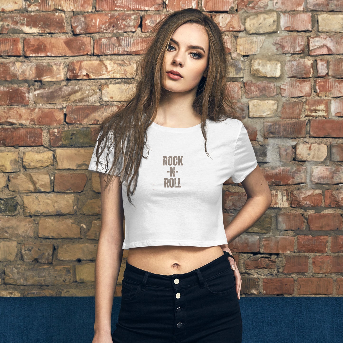 tylish woman wearing a white 'ROCK -N- ROLL' slogan crop top, combining classic rock edge with modern street style.