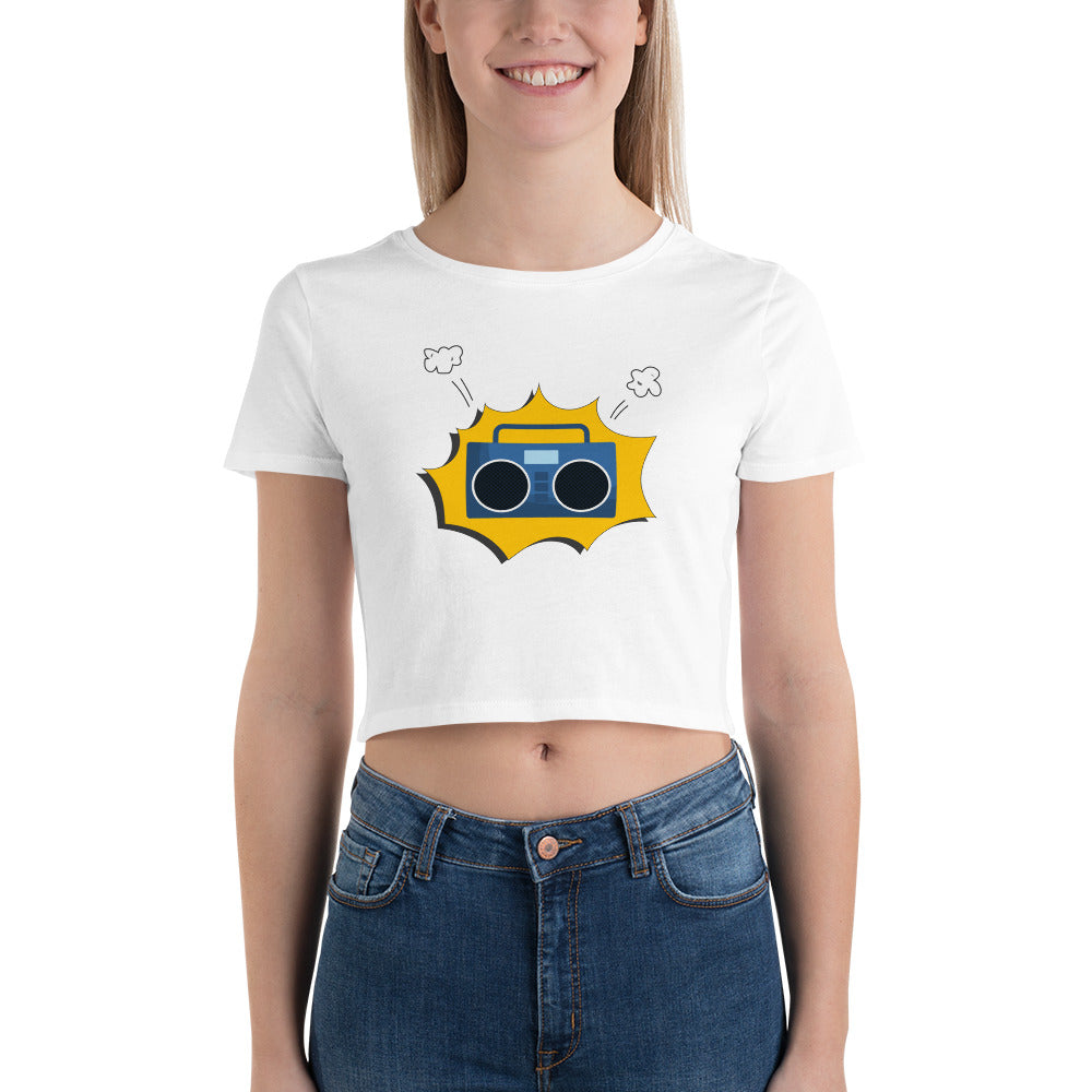 Smiling woman in a white crop top featuring a retro yellow boombox design with white accents.