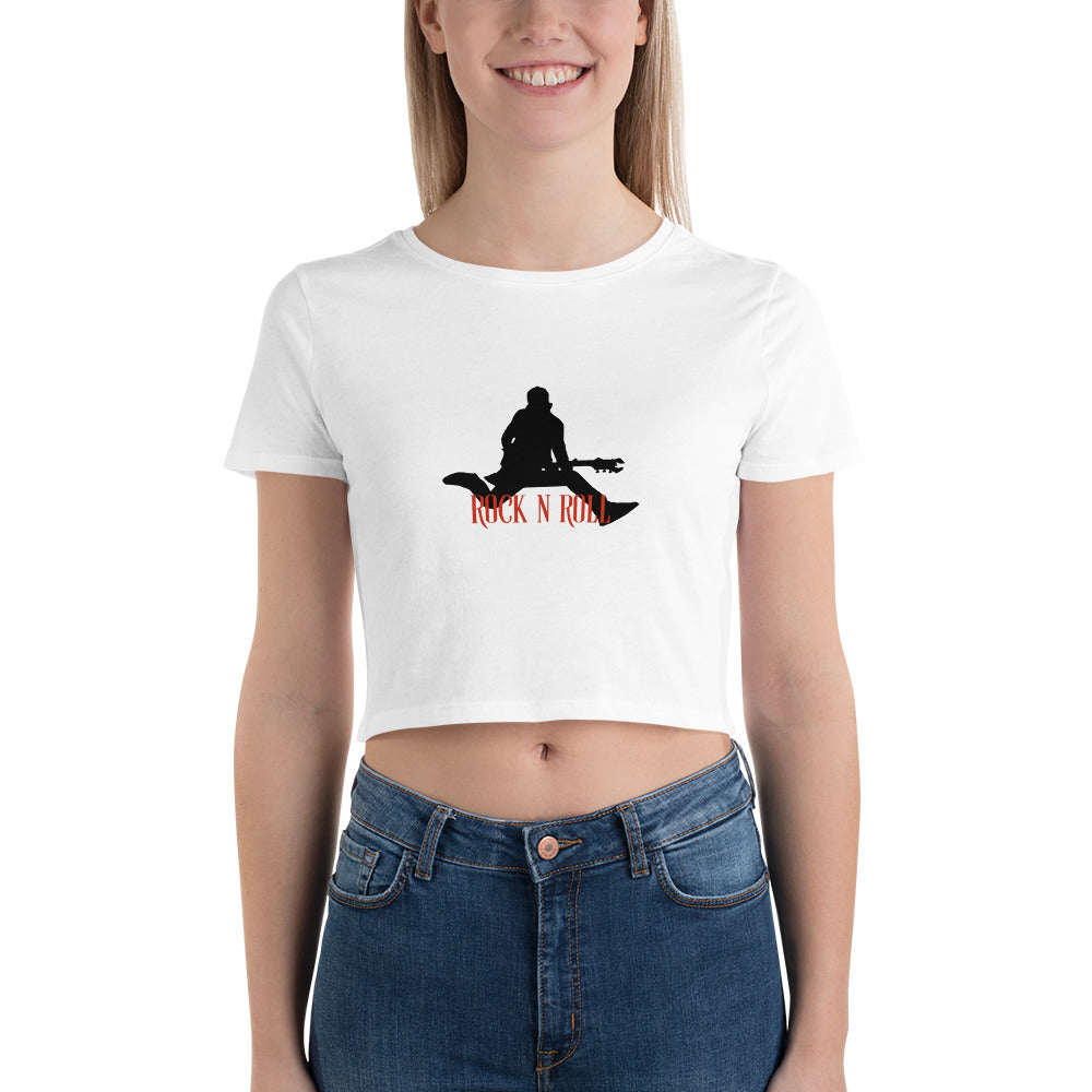 Smiling woman sporting an white crop top featuring a bold "Rock N Roll" slogan and guitarist silhouette.