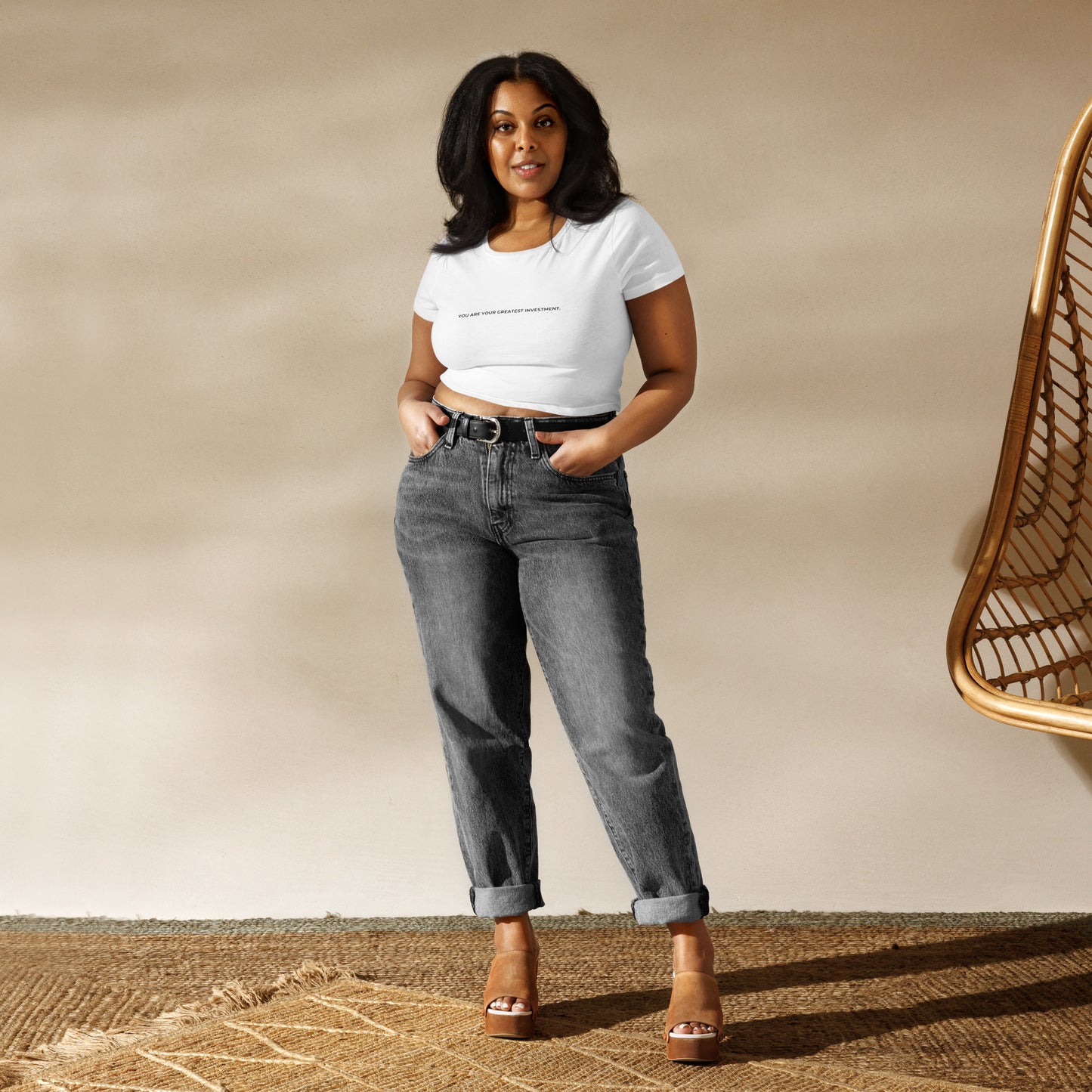 Empowering slim-fit white crop top for women with "You Are Your Greatest Investment" quote. 